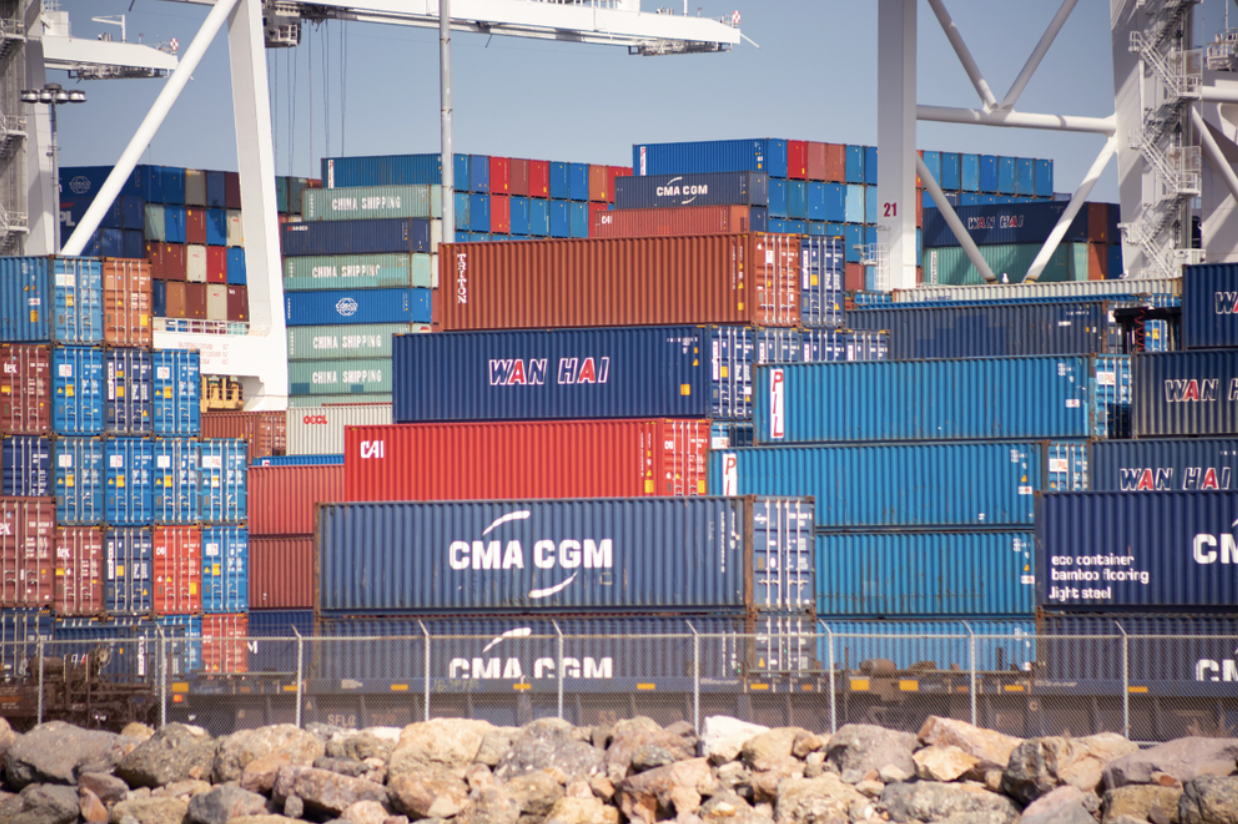 A picture of shipping carts stacked on top of each other at a port.