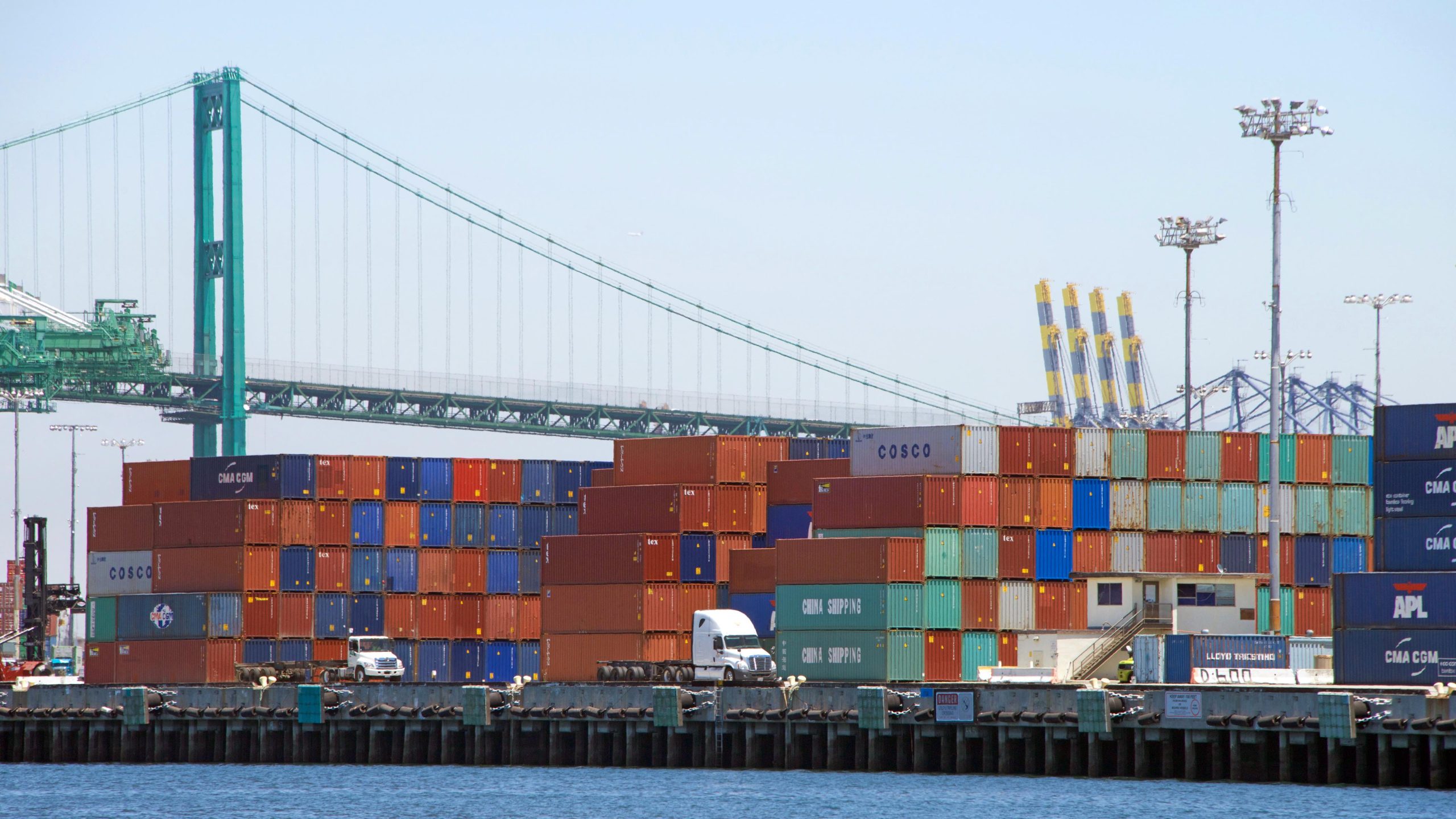 Shipping containers stacked on docks at shipping port in Los Angeles.